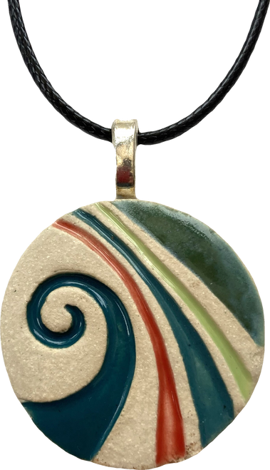 Handmade white stoneware swirl pendant, decorated with teal, red and green ceramic glaze. With a stainless steel backing and a black cord necklace.