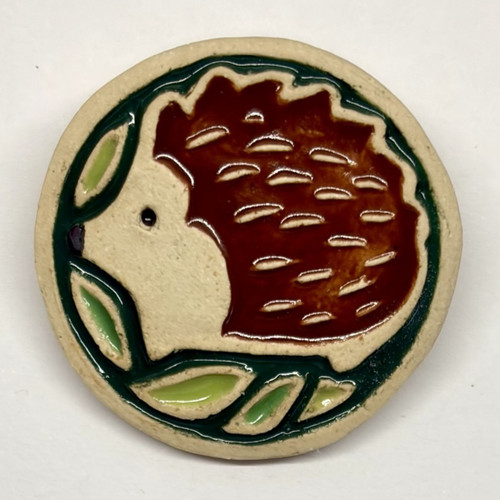 Handmade Hedgehog brooch made using stoneware clay and glazes.
