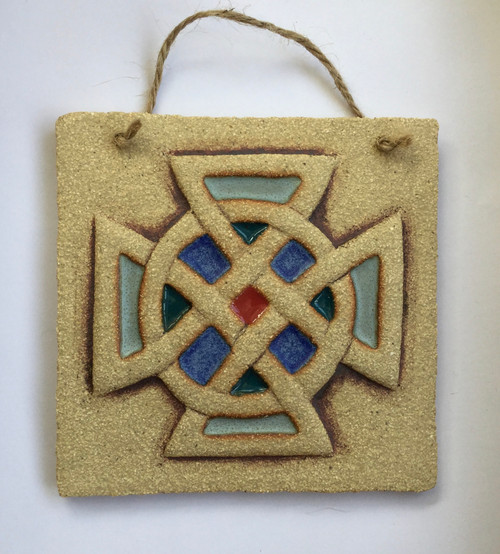 Knot plaque made from a textured stoneware clay, coloured glazes and oxide.
Hessian string added to hang.