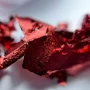 Close-up texture of Hessi Red Flakes Effect showing shiny red foil flakes, perfect for broken-glass style manicures, festive nails and decorative gel polish designs.