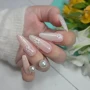 YOSHI Shimmer Top Gold floral almond manicure with gold shimmer finish