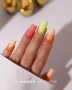 Professional manicure featuring nails painted in a delicate peach shade, creating an elegant pastel nail design inspired by Makear 557 Hybrid Gel Polish.