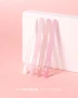 Makear Milky French Gel Polish shade comparison featuring four nail swatches labelled 602, 603, 604 and 605. Displayed against a soft pastel pink background, the image showcases delicate milky white, soft pink and nude pink tones, with Makear 605 appearing as the most distinctly pink shade in the collection.