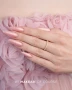 Elegant manicure featuring long, almond-shaped nails painted in a delicate blush pink shade with fine pearlescent shimmer and a glossy finish. The manicure is complemented by a delicate gold ring and soft pink floral tulle, creating a romantic, feminine nail design associated with Makear 640 Hybrid Gel Polish.