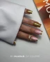 Elegant professional manicure featuring neatly shaped nails finished in a coordinated gold gel polish colour with noticeable Premium Glitter particles and a smooth, glossy surface. The sparkling full-colour design is inspired by Makear 806 Hybrid Gel Polish and demonstrates glamorous salon nail styling suitable for evening occasions, Christmas celebrations, New Year's Eve manicures and other special events. The photograph highlights the reflective gold finish and consistent decorative coverage across the nails.