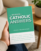 An adult holds The Big Book of Catholic Answers, Volume 3: The Life of Faith, with the green-and-white front cover facing the viewer.
