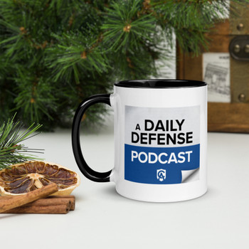 Daily Defense Podcast ceramic mug with black interior, rim, and handle, shown filled with coffee for a bold morning look.