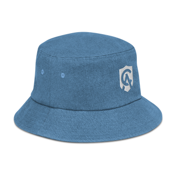 A clean studio shot of the denim bucket hat showing its texture, logo, and stitched eyelets on a neutral background.