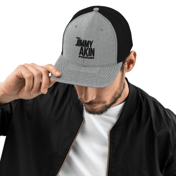 Stylish trucker hat featuring The Jimmy Akin Podcast logo for fans of Catholic apologetics and the Faith.