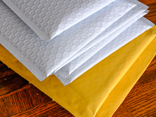 Padded plastic and paper mailers