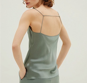 Woman in green loungewear with her back turned