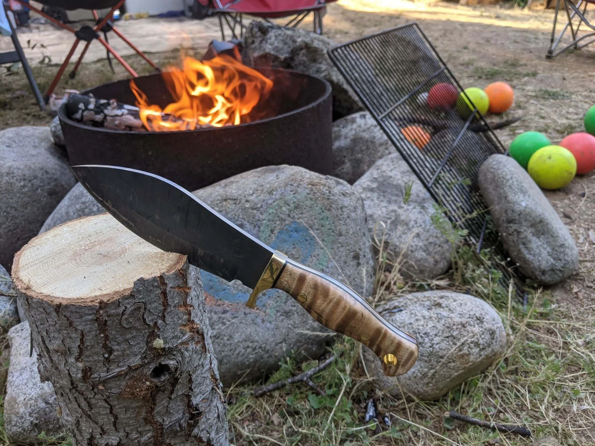QuickHatch knife beside a campfire