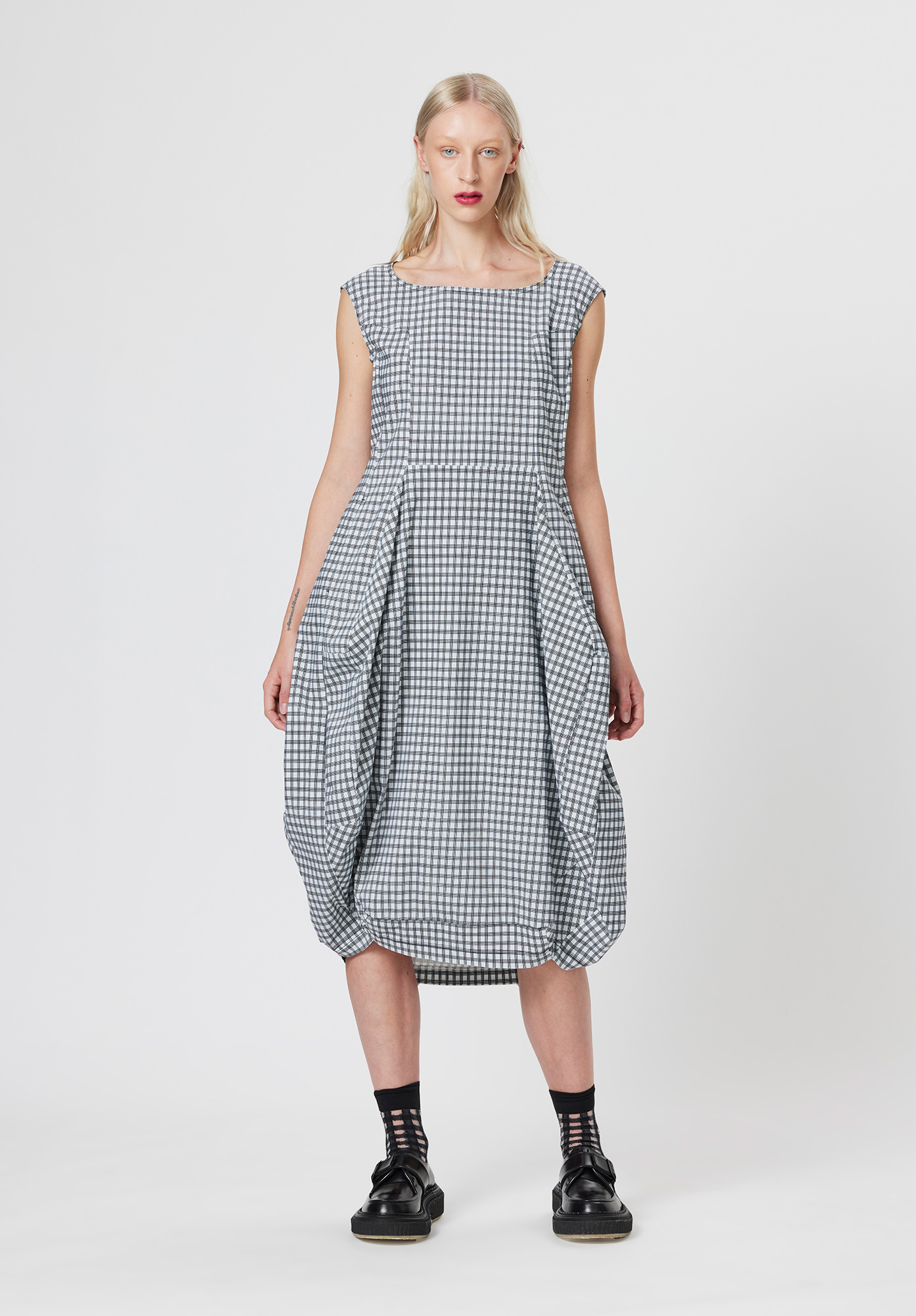 The Check hexagonal dress creates a dramatic semi-tulip style skirt with a multitude of curved panels, complementing the semi-fitted bodice and round scoop neckline.  Constructed in Studio Rundholz signature mid-weight Techno Stretch fabric this surely is a dress for all seasons. 

- Wide Shoulder straps
- Semi-fitted bodice
- Tulip hem
- Hidden in-seam pockets

Pair with a contrasting crop jacket and sheer mesh top for an alternative style.

Designed in Germany by Studio Rundholz