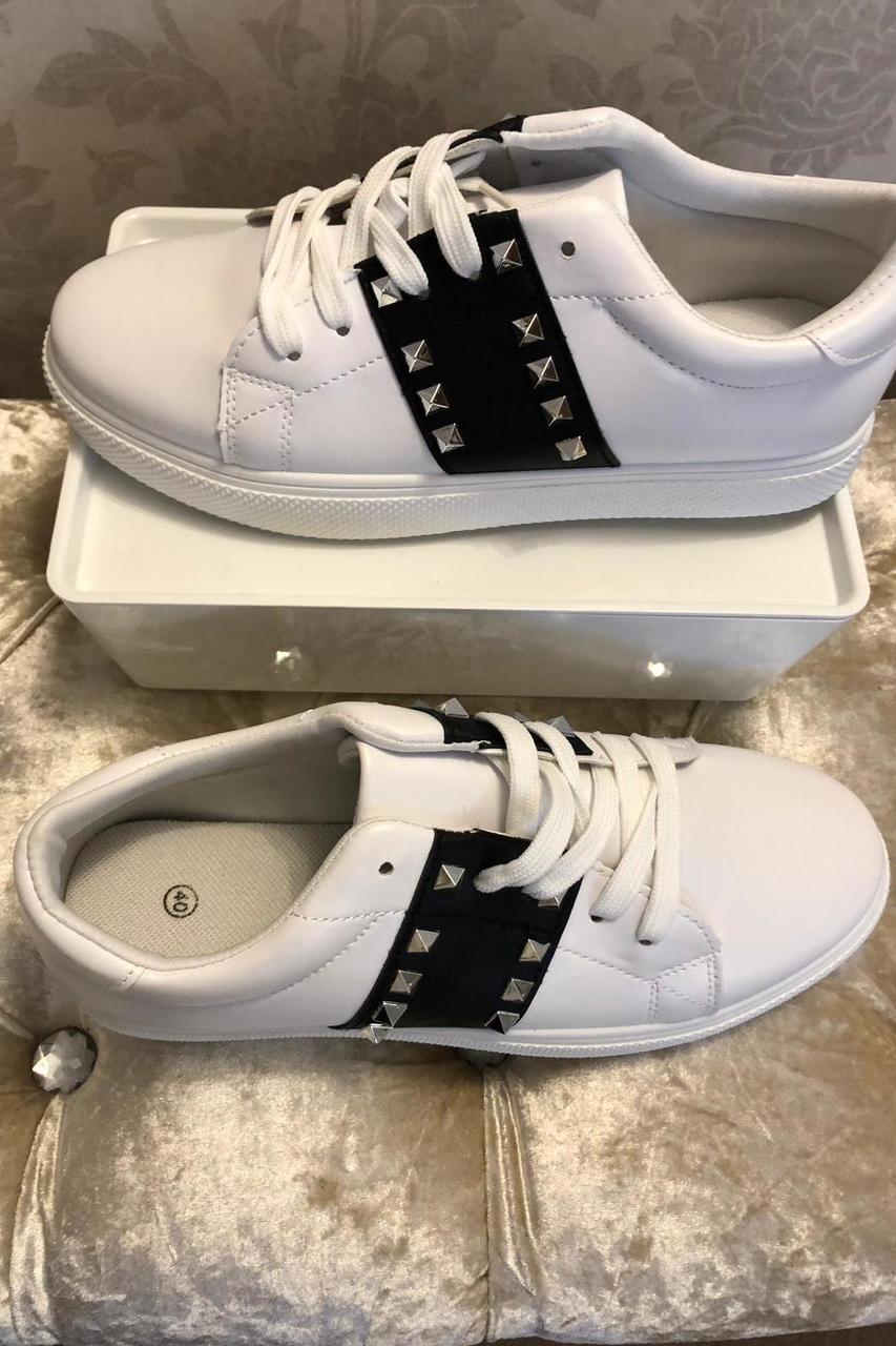 white trainers with black stripe