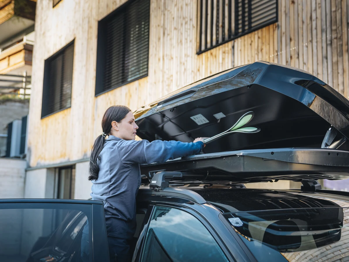 Loading gear into a Thule rooftop cargo box