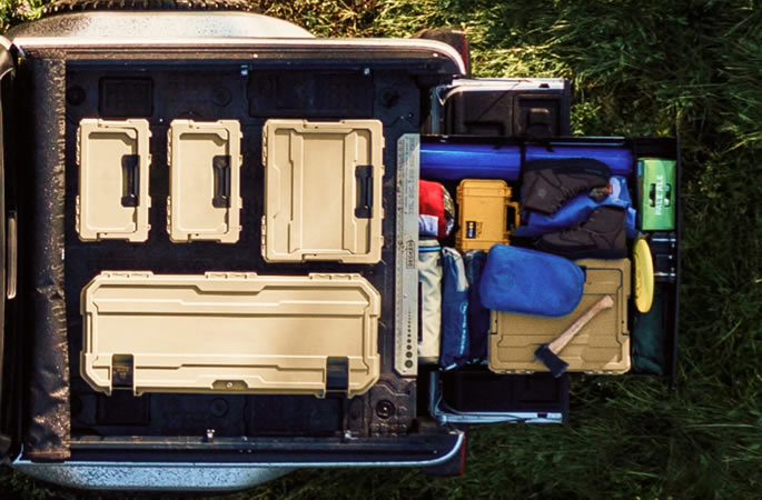 Tailgate-to-wheel-well pass-throughs and stash bins