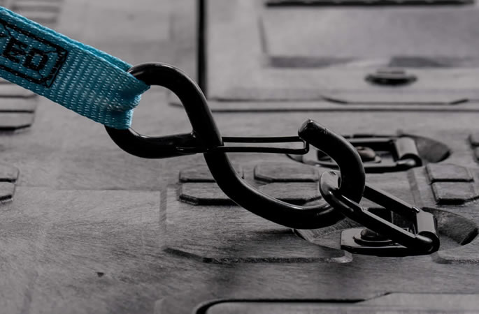 Integrated D-ring tie-downs along the system edge