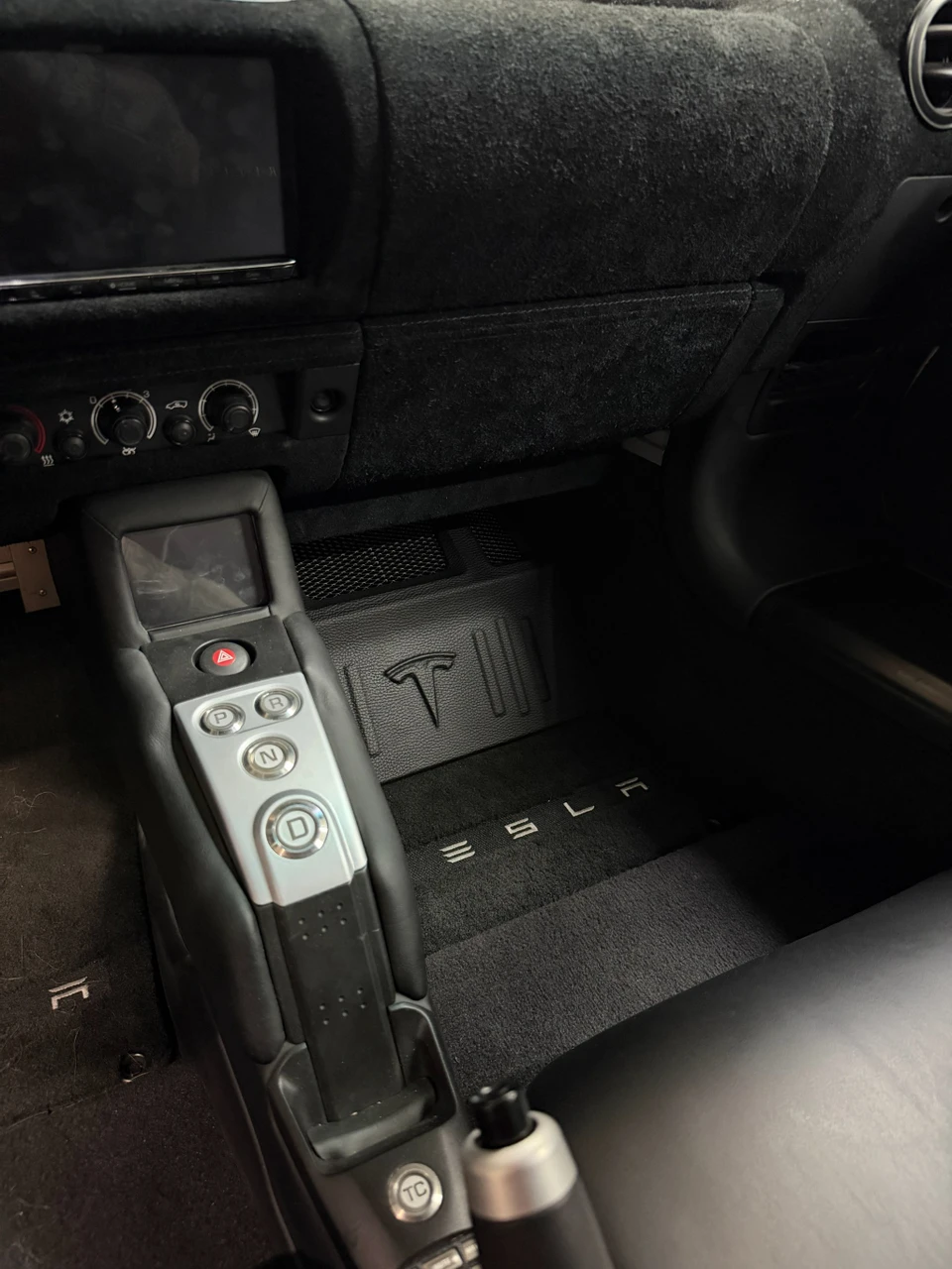 Stealth subwoofer installation hidden in the Tesla Roadster interior