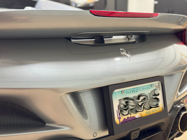 Detail of the custom license plate mount on the Ferrari F8