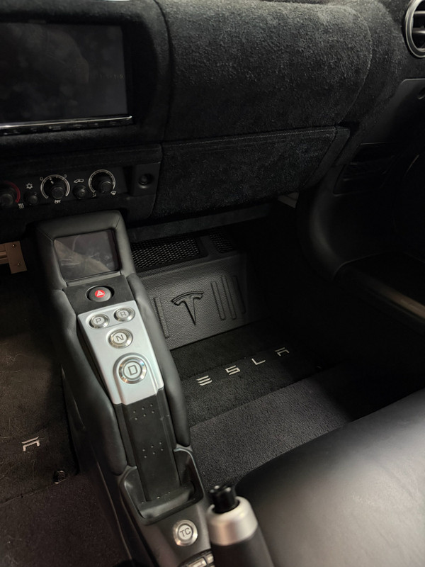 Stealth subwoofer installation hidden in the Tesla Roadster interior