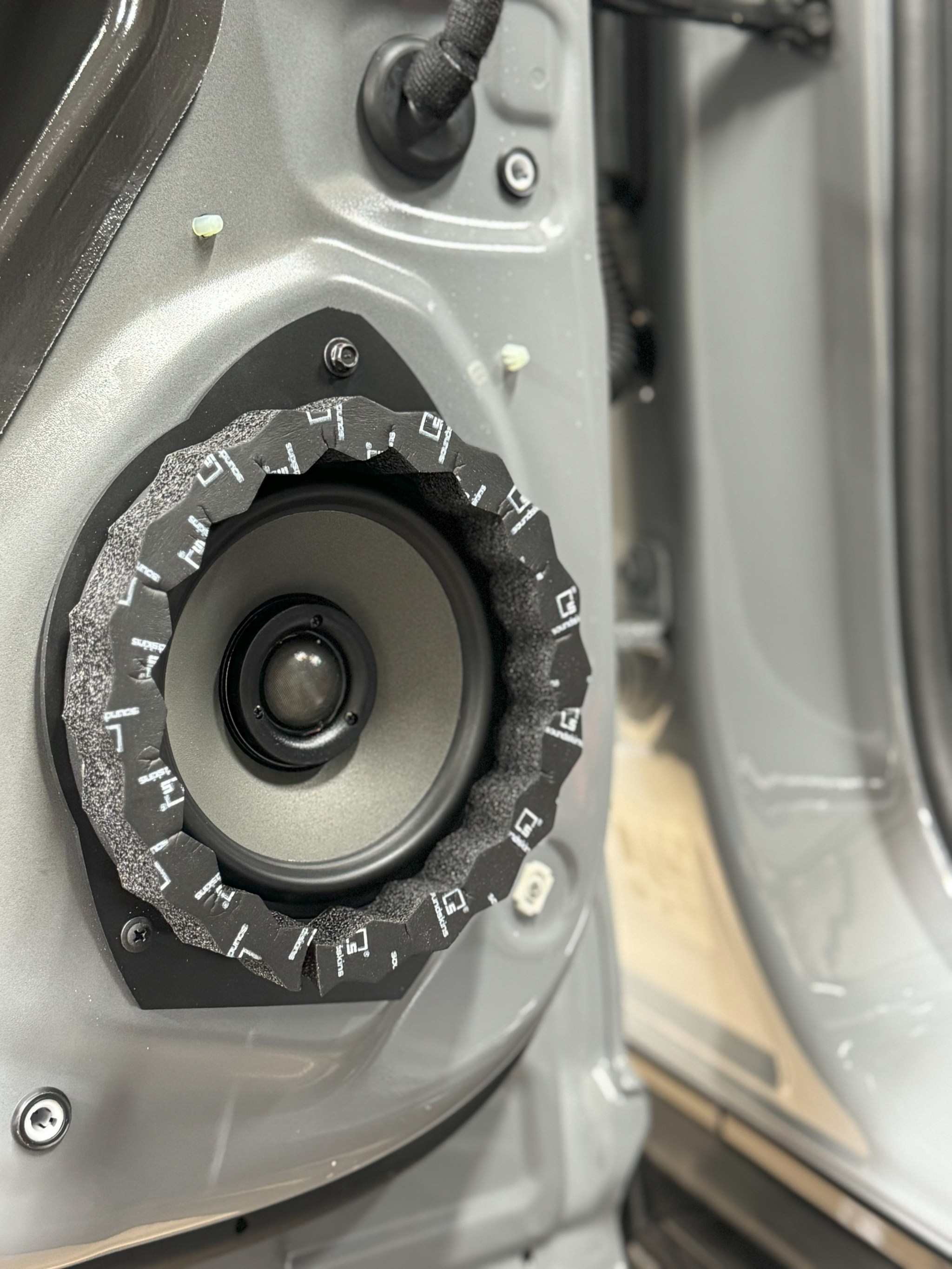 Upgraded door speaker behind the factory grille location in the Hummer EV