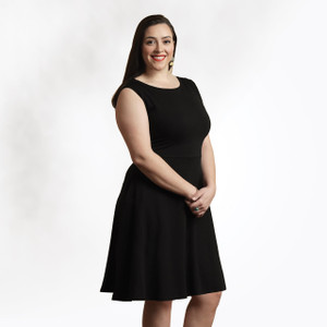 Front view of model wearing Black solid color organic cotton Sleeveless Crossover Dress. Front view of model wearing Black solid color organic cotton Sleeveless Crossover Dress.