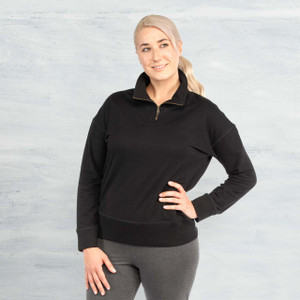 Person with blonde long hair pulled back and light skin wearing Black solid color organic cotton Quarter Zip Fleece Pullover. Person with blonde long hair pulled back and light skin wearing Black solid color organic cotton Quarter Zip Fleece Pullover.