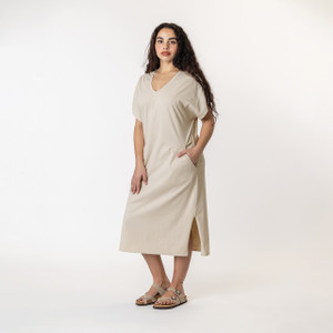 Side full body view of model wearing organic cotton kaftan dress in pearl. Side full body view of model wearing organic cotton kaftan dress in pearl.