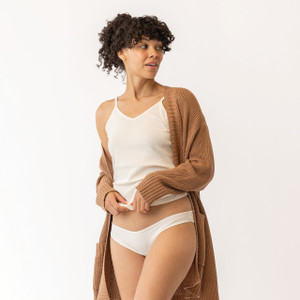 Close up front view of model wearing organic Cotton Women's Low-Rise Bikini in color natural.