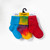 Red solid color, tie-dyed colorful, and bright blue solid color organic cotton baby anklet socks. Pack of three in yellow store packaging. Red solid color, tie-dyed colorful, and bright blue solid color organic cotton baby anklet socks. Pack of three in yellow store packaging.