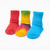 Red solid color, tie-dyed colorful, and bright blue solid color organic cotton baby anklet socks. Pack of three. Red solid color, tie-dyed colorful, and bright blue solid color organic cotton baby anklet socks. Pack of three.