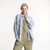 Front view of model wearing organic cotton workwear shirt in color denim blue Front view of model wearing organic cotton workwear shirt in color denim blue