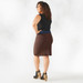 Person with curly brown shoulder length hair and dark skin and is wearing toffee reversible organic cotton pencil skirt shown from the back.