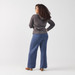 Back view of model wearing sweater pants in the color blue heather.