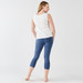 Model wearing blue distressed color organic cotton midcalf base layer leggings shown from the back.