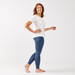 Model wearing blue distressed color organic cotton ankle base layer leggings.