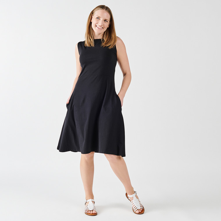 Front view of model wearing organic cotton fit & flare dress in black.