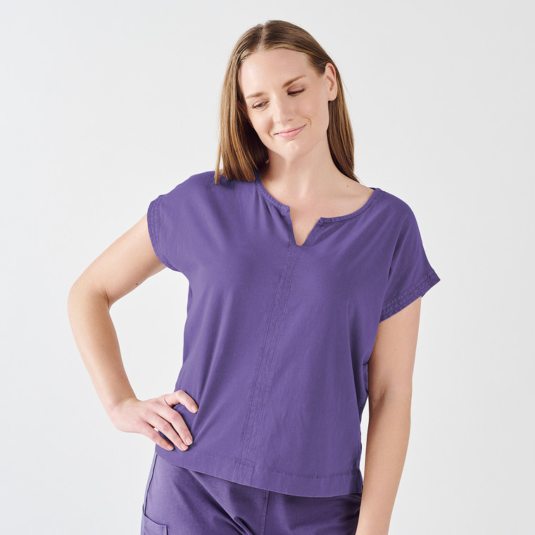 Front view of model wearing organic cotton cocoon top in color viola distressed.
