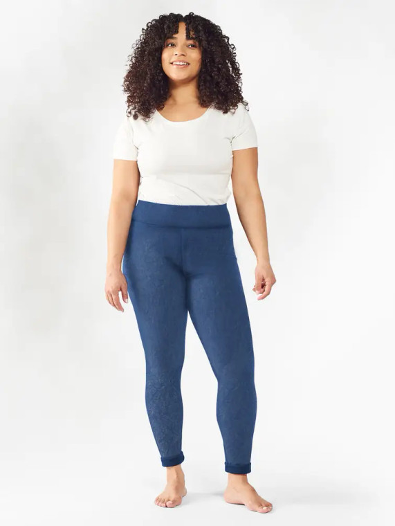 Front close up view of model wearing organic cotton distressed legging in color blue.