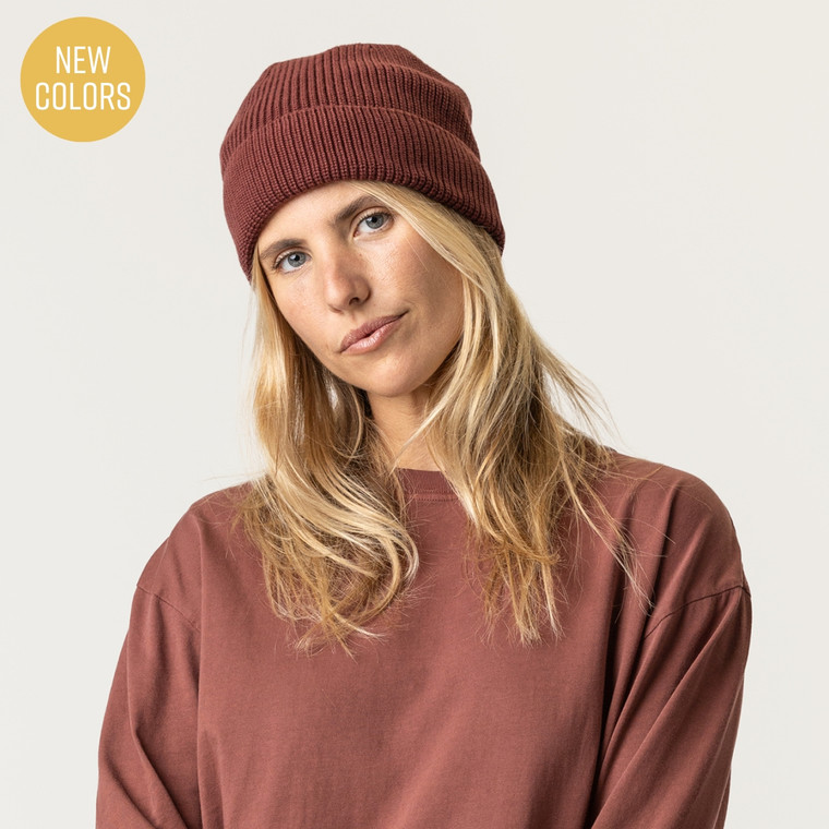 Model wearing organic cotton fisherman beanie in color masala