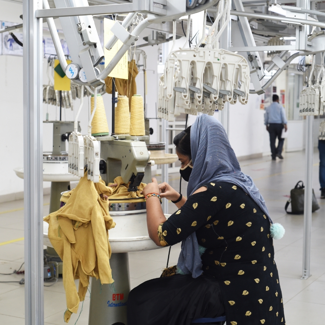 Trade union worker sewing Maggie's apparel..