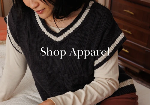 Image of woman wearing a sweater vest over pearl layering tee with text overlay that reads  "Shop Apparel 
