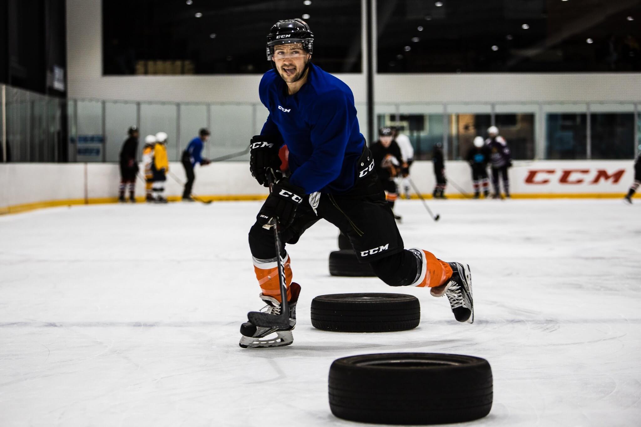 Hockey Player Practicing In Between Tires