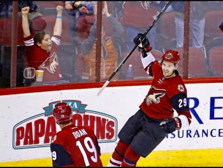 Figure 24 Celebrating a goal with the Legend Shane Doan in my rookie season a few months later being called up.