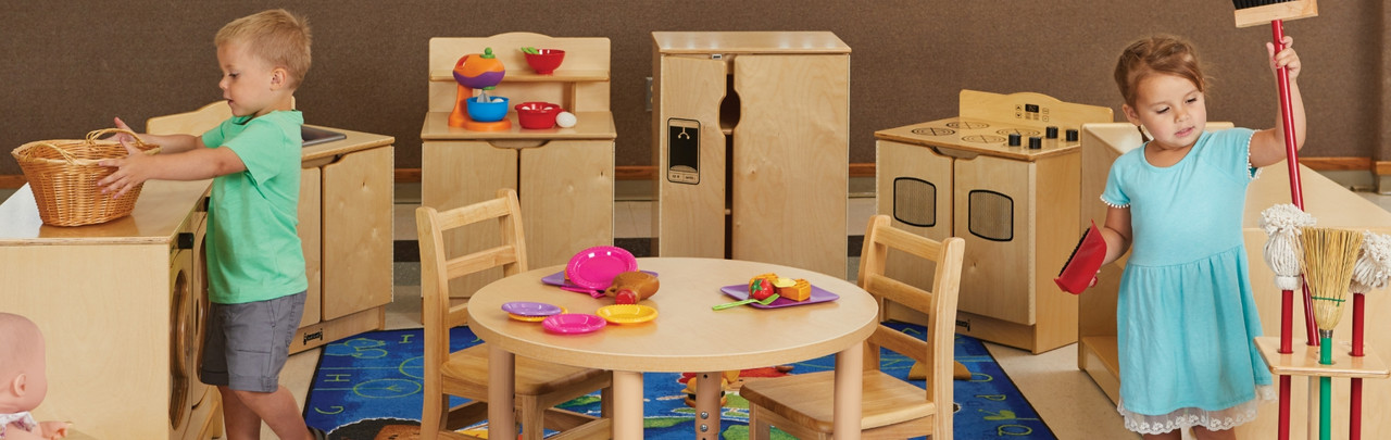 children using pretend play furnishings