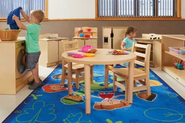 Two kids in play kitchen set up