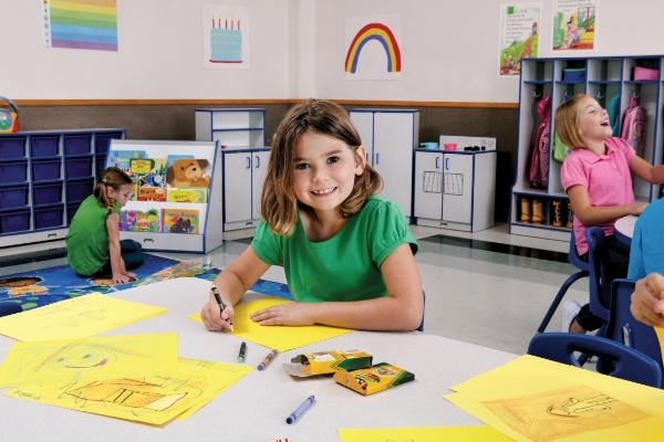 Girl sitting at table coloring