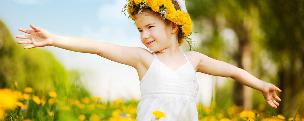 Little girl with flower crown outside smiling