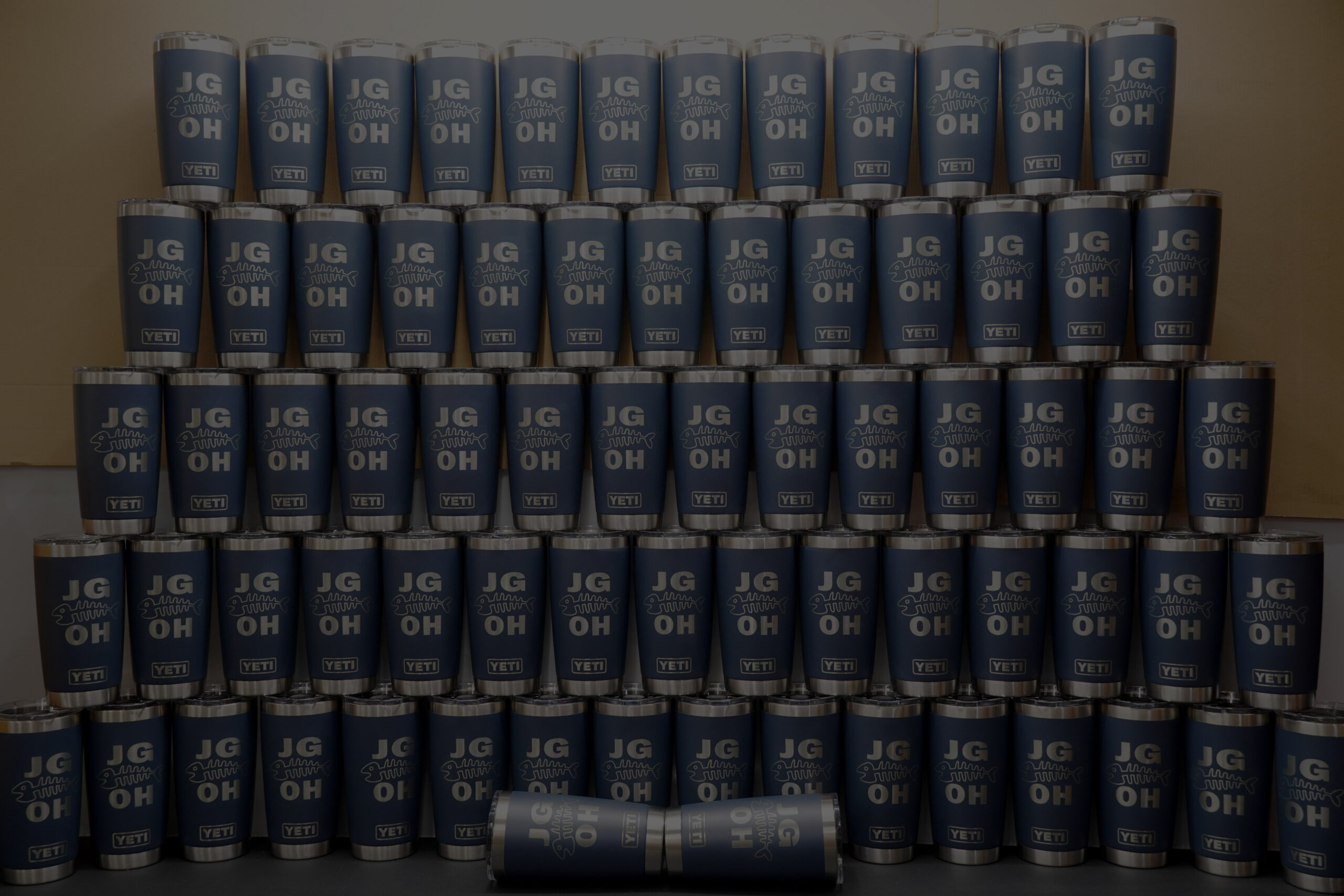 A large completed order of engraved blue tumblers