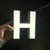 Front lit stainless steel brand wall letter sign